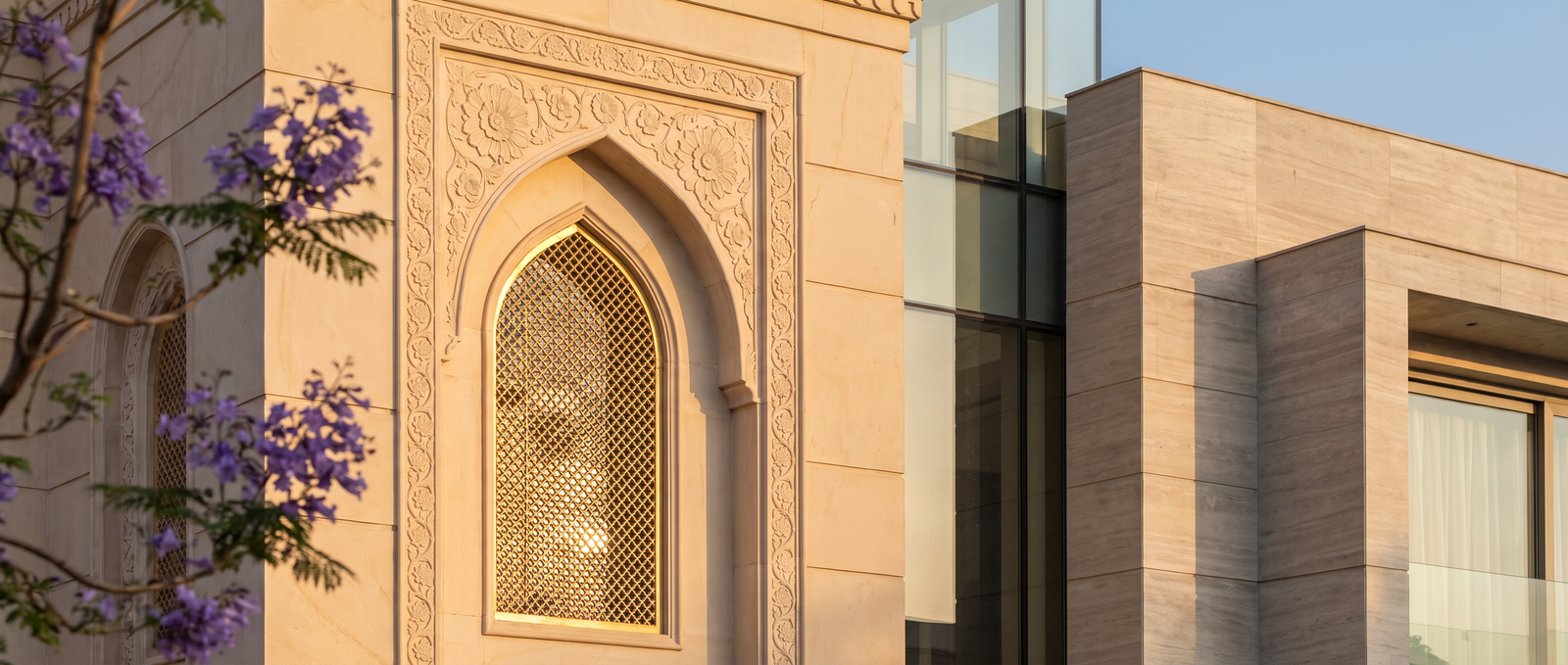 Carved sandstone arch and jaali detail on a KB Realty building