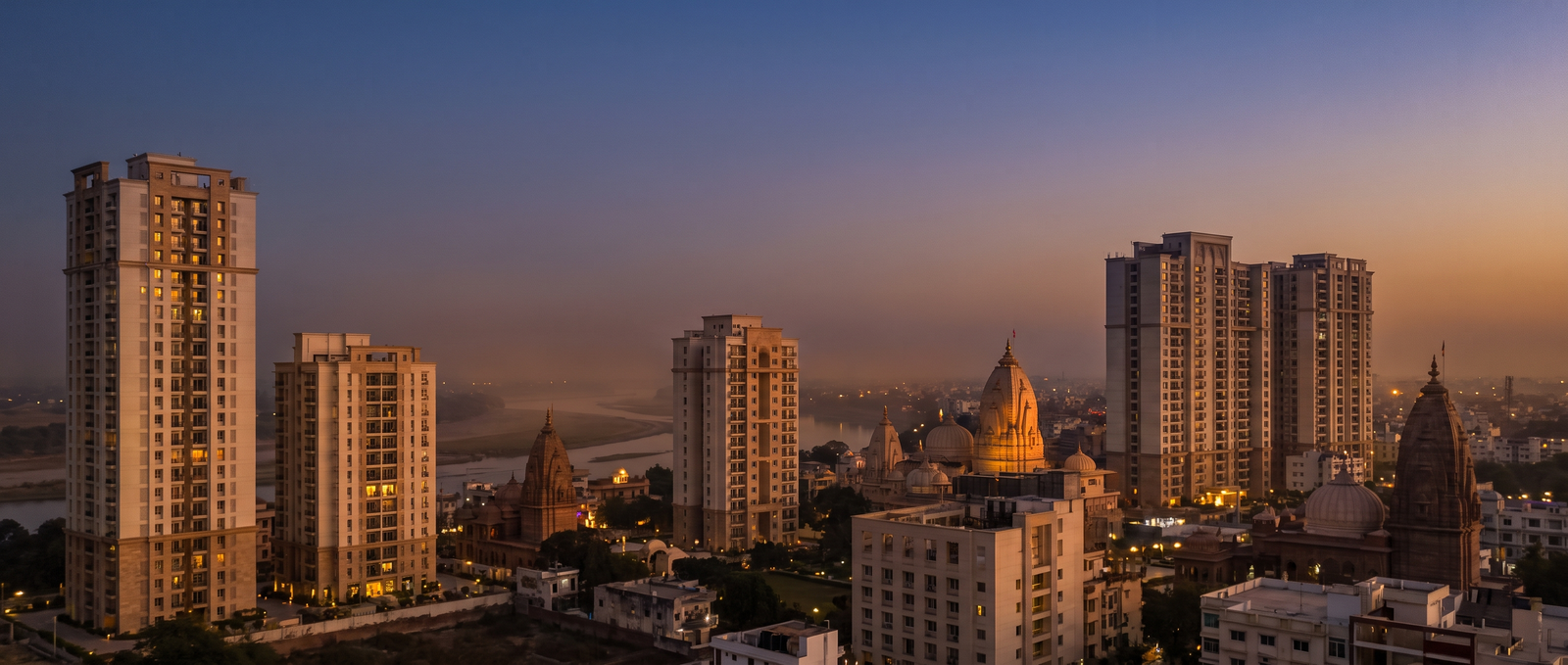 Vrindavan skyline at dusk with residential towers and temple domes